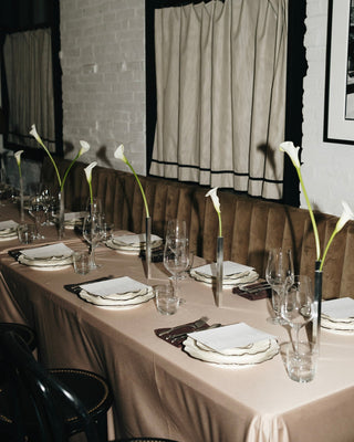Aureum x LES Collection dinner table setting with calla lilies, candles, and handcrafted ceramics.